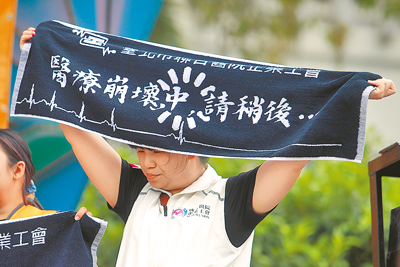 教育部同意以公費生名額設系的清華、中興、中山3校學士後醫學系,引爆醫界怒火。圖為2025年5月1日,台北市聯合醫院企業工會成員高舉毛巾標語,抗議低薪、高工時工作環境,已讓醫療體系崩壞。(本報資料照片) image
